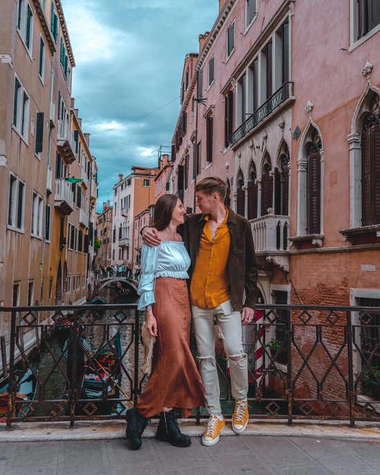 Couple Stands on the Bridge in Venice