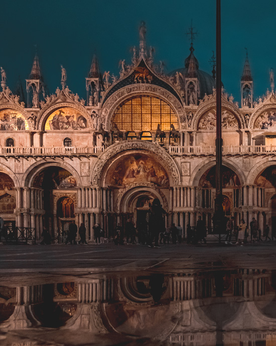 Basilica San Marco in Venice Italy at night with reflections in the water
